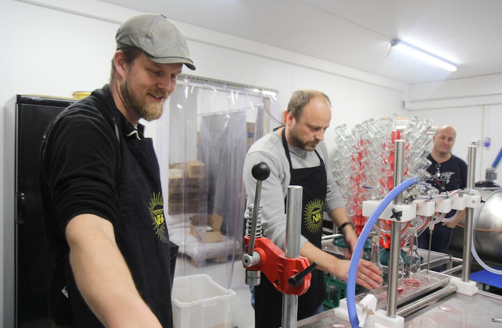 Eivind Alsaker og Roald Pedersen er i full sving med å tappe julebrusen på flasker. 
Foto: Ingvild R. Myklebust